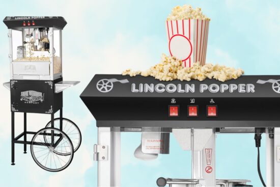 Black Lincoln Popcorn Machine with cart and switches, shown with popped popcorn and a red-striped tub on top.