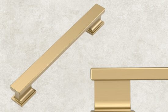 Champagne bronze cabinet pull with a brushed gold finish on a light stone background.