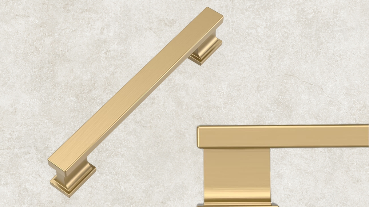 Champagne bronze cabinet pull with a brushed gold finish on a light stone background.