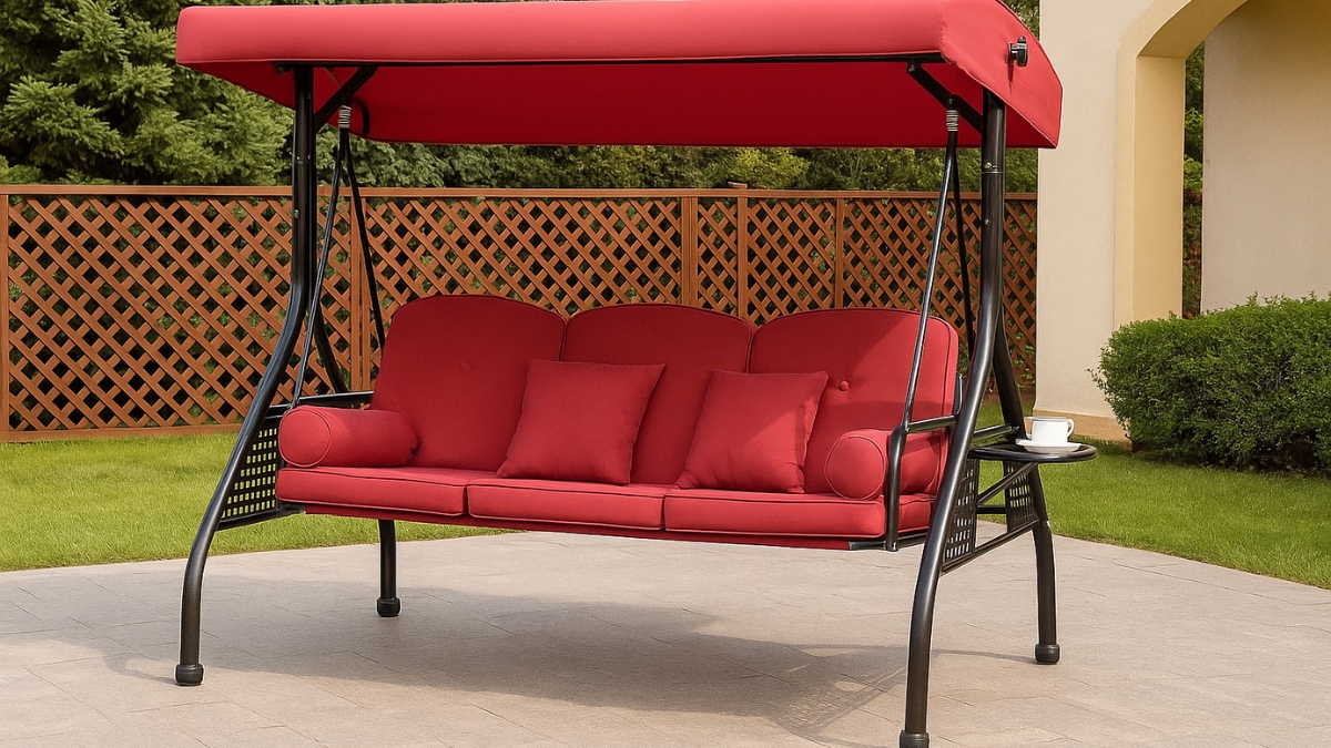 Red 3 in 1 outdoor porch swing with cushions, canopy, pillows, and cup holders on a patio.