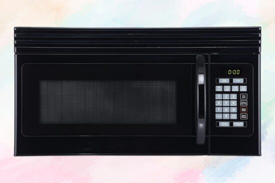 Black BLACK+DECKER over-the-range microwave with digital controls and vent system shown on a soft background.