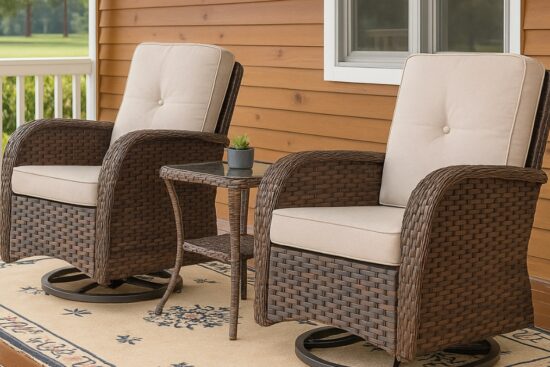 Two patio swivel rocking chairs with beige cushions and a small wicker side table on a porch.