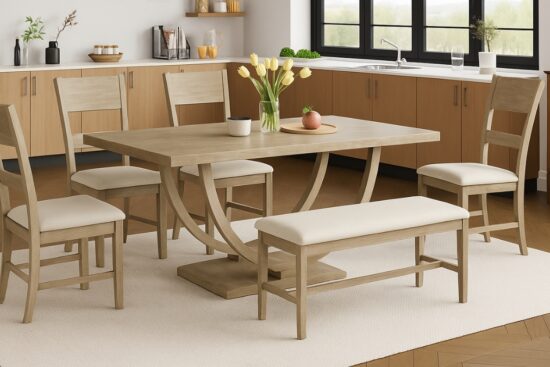 Farmhouse dining table set with four chairs and a bench in a light wood finish inside a modern kitchen.