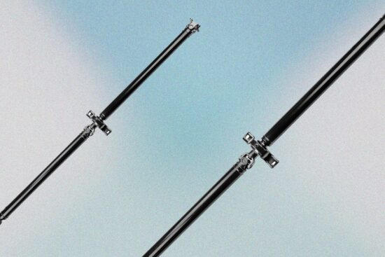 Two black rear drive shafts with U-joints shown on a light blue gradient background.