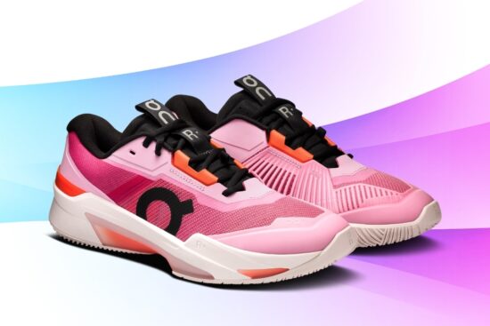 On Cloud tennis shoes in a bright pink and orange colorway, featuring mesh uppers, cushioned midsoles, and a modern court-ready design on a colorful gradient background.