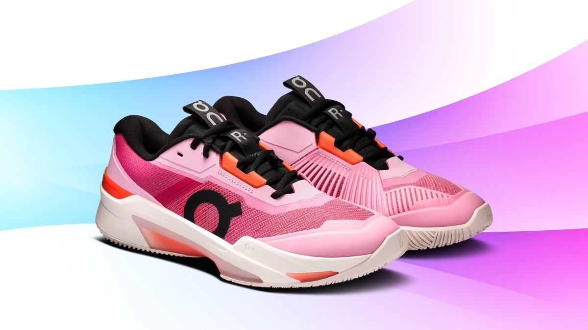 On Cloud tennis shoes in a bright pink and orange colorway, featuring mesh uppers, cushioned midsoles, and a modern court-ready design on a colorful gradient background.