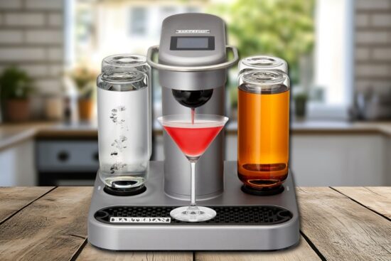 Bartesian Premium Cocktail and Margarita Machine dispensing a red cocktail into a martini glass on a kitchen counter, with spirit reservoirs filled and ready for mixing.
