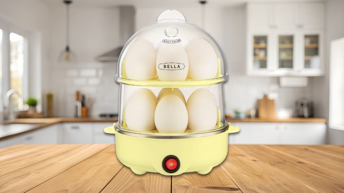 BELLA Rapid Electric Egg Cooker and Omelet Maker in yellow on a kitchen counter, filled with eggs in a double-stacked tray design.