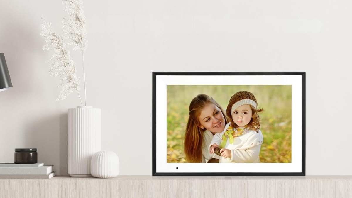 Anna Bella Digital Photo Frame displaying a clear family photo on a modern tabletop frame with a slim black bezel in a bright home setting